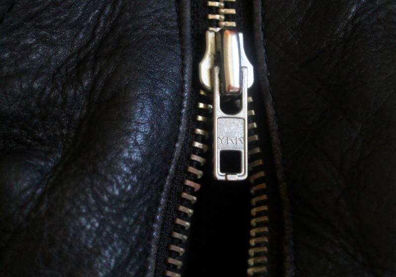A zipper on a jacket with the YKK logo in Macon.